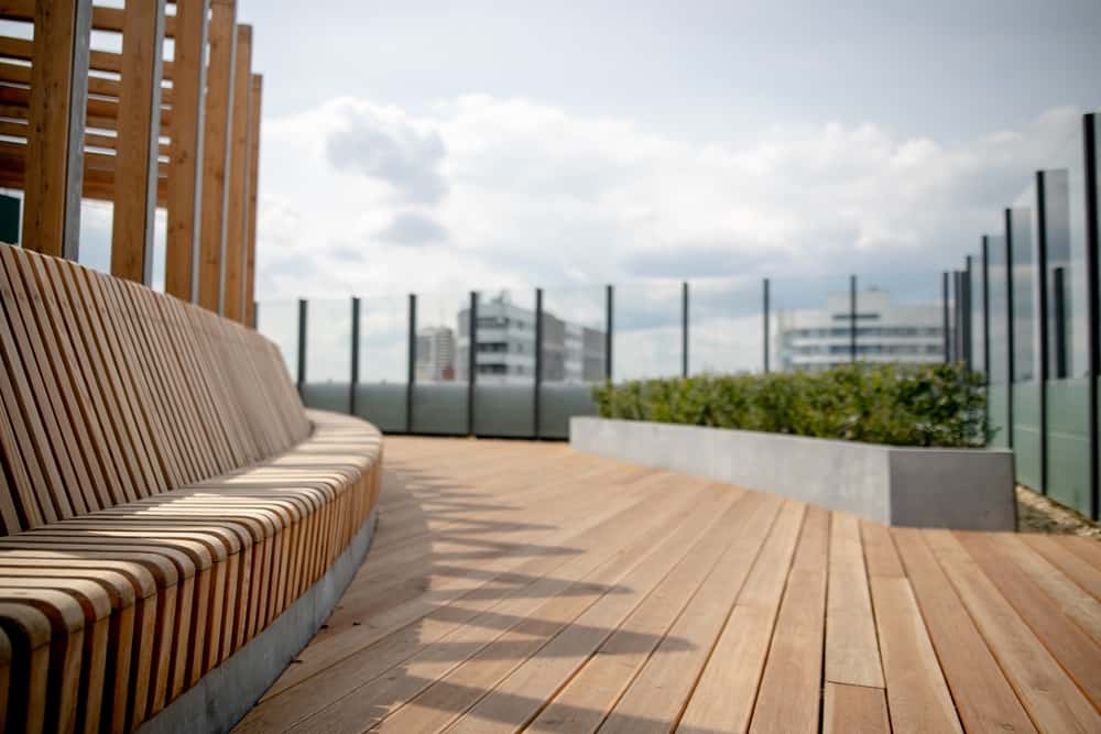 Panorama View Of Modern Rooftop Terrace With Dark Wood Deck