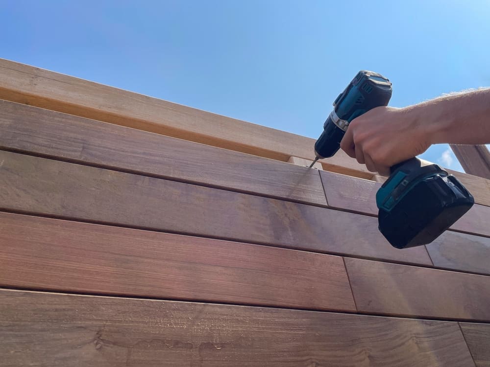 Carpentry Worker Building Wooden Deck Siding Boards Close Up